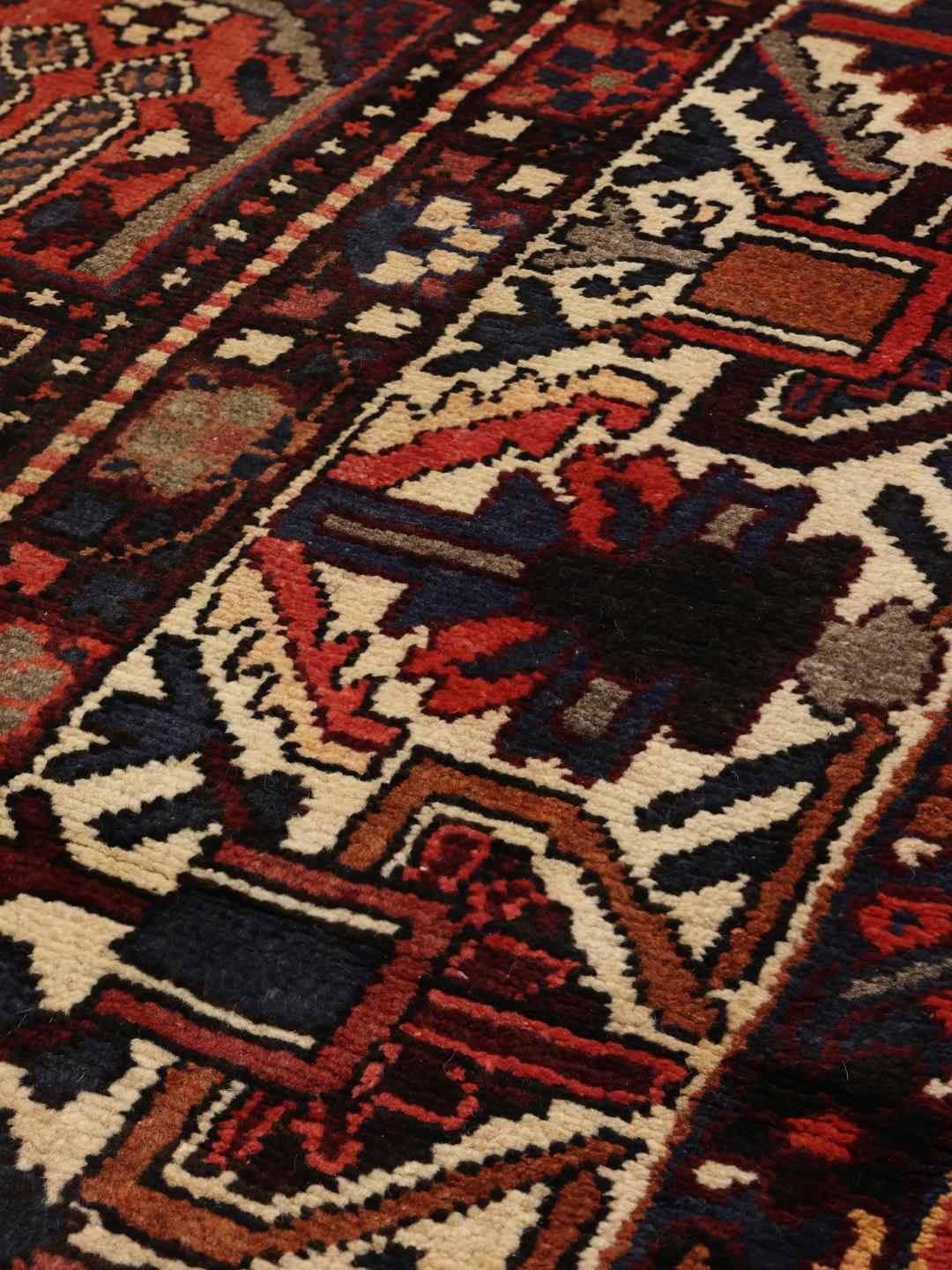 Hand-knotted Bakhtiari rug from the Middle East in dark red and multicolour hues.