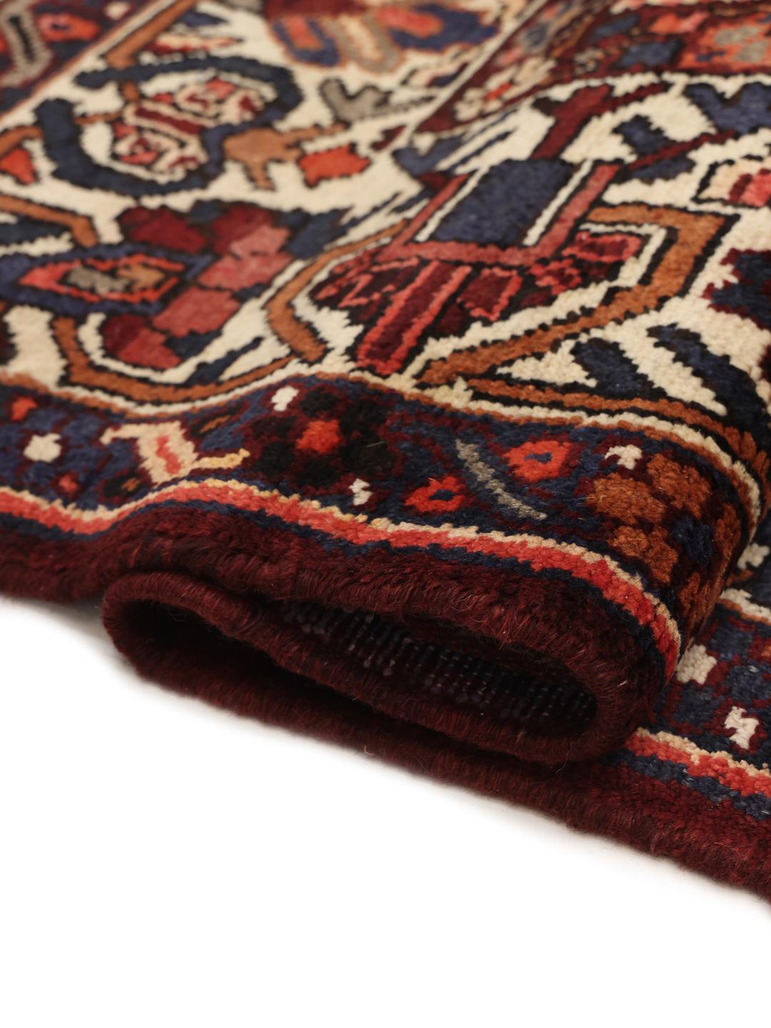 Hand-knotted Bakhtiari rug from the Middle East in dark red and multicolour hues.