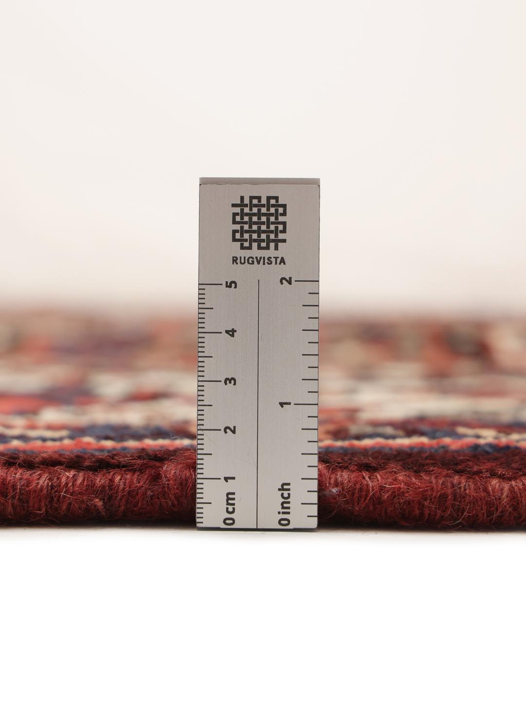 Hand-knotted Bakhtiari rug from the Middle East in dark red and multicolour hues.