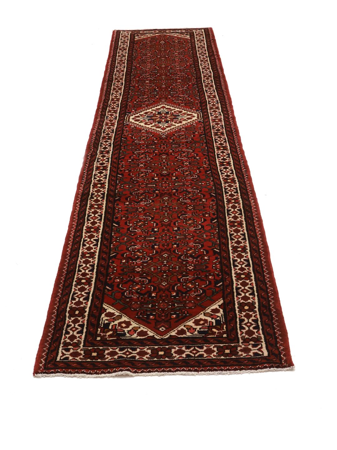 Hand-knotted Hosseinabad runner in red featuring traditional patterns.