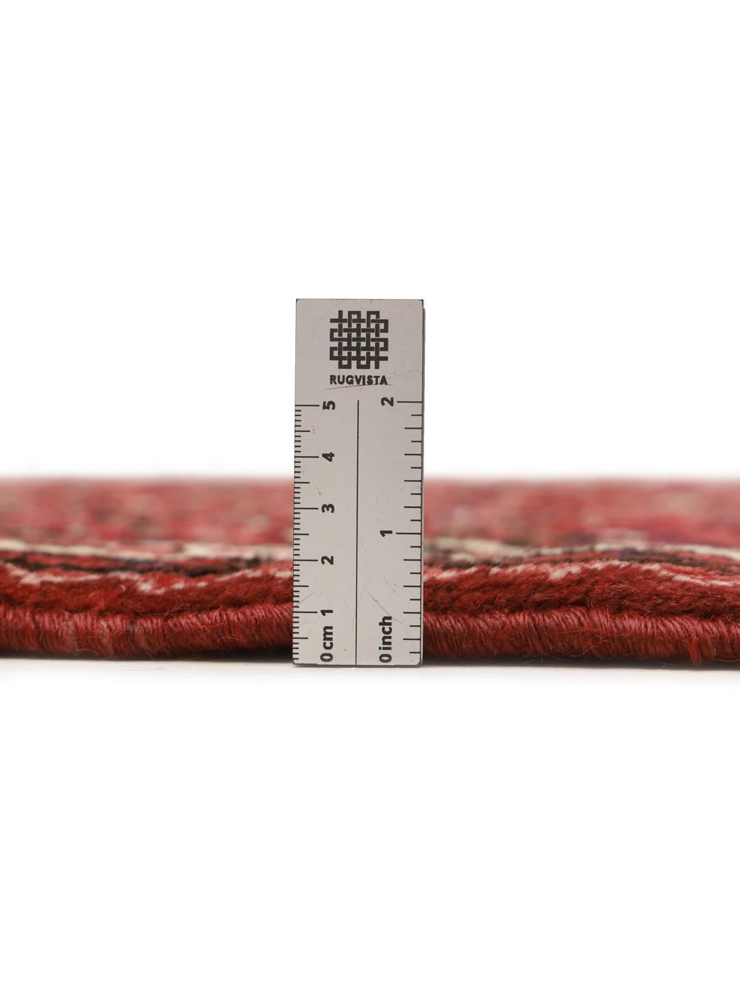 Hand-knotted Hosseinabad runner in red featuring traditional patterns.