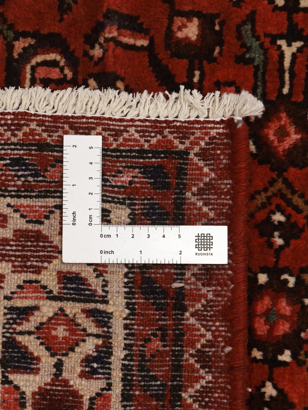 Hand-knotted Hosseinabad runner in red featuring traditional patterns.
