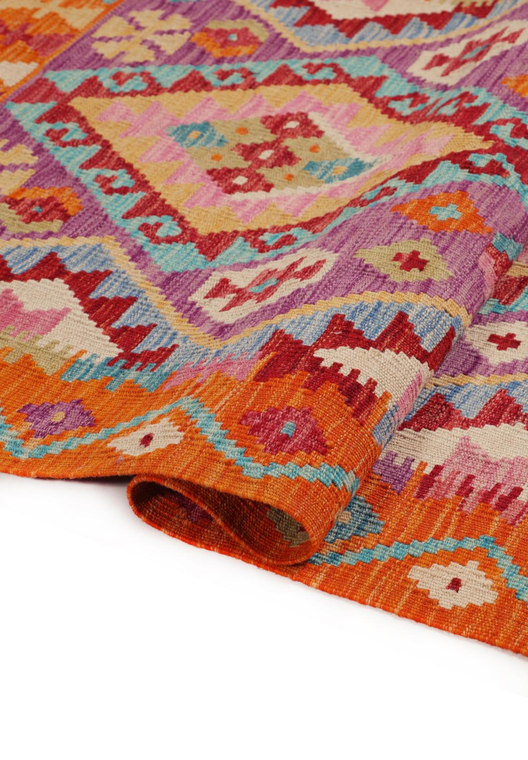 Hand-woven Afghan Kelim rug featuring geometric patterns in orange, purple, and blue.