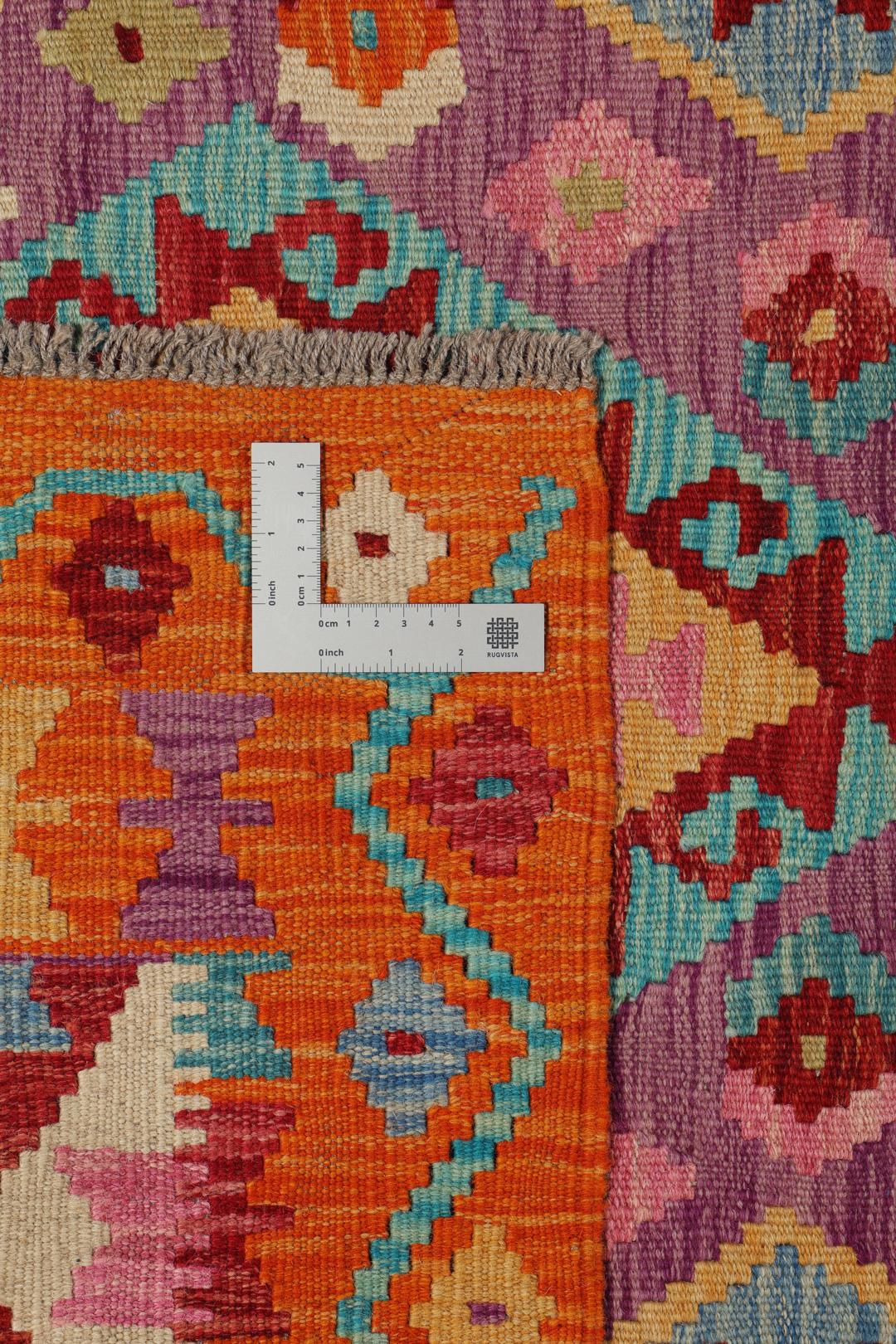 Hand-woven Afghan Kelim rug featuring geometric patterns in orange, purple, and blue.