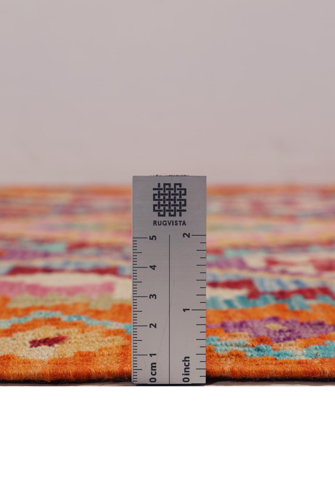 Hand-woven Afghan Kelim rug featuring geometric patterns in orange, purple, and blue.