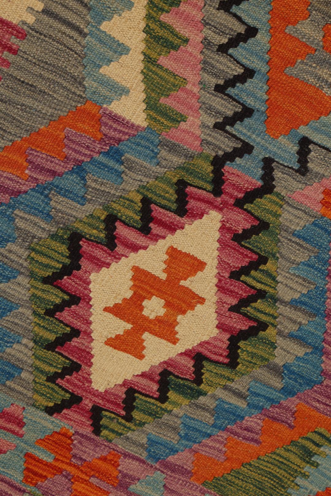 Hand-woven Afghan Kelim rug featuring vibrant geometric patterns in multicolor Wool