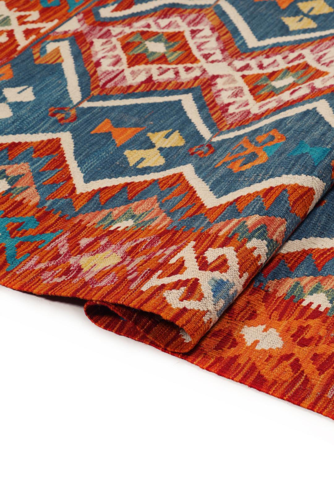 A rectangular, hand-woven Kelim Afghan rug featuring geometric patterns in blue, red, and orange tones.