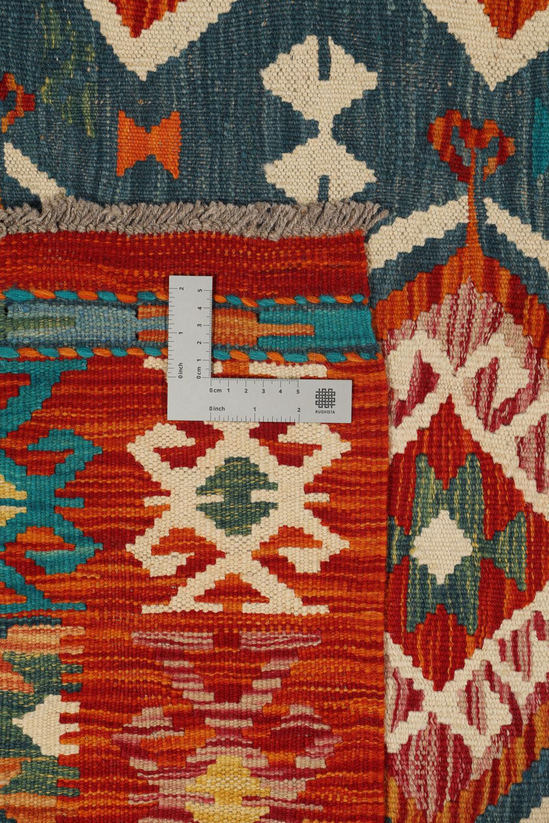 A rectangular, hand-woven Kelim Afghan rug featuring geometric patterns in blue, red, and orange tones.