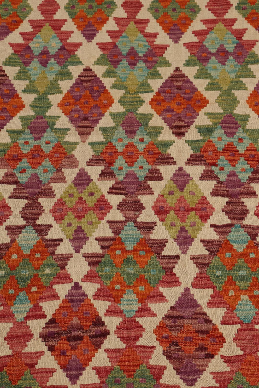Hand-woven Afghan Kelim rug featuring a vibrant, multi-coloured geometric diamond pattern.