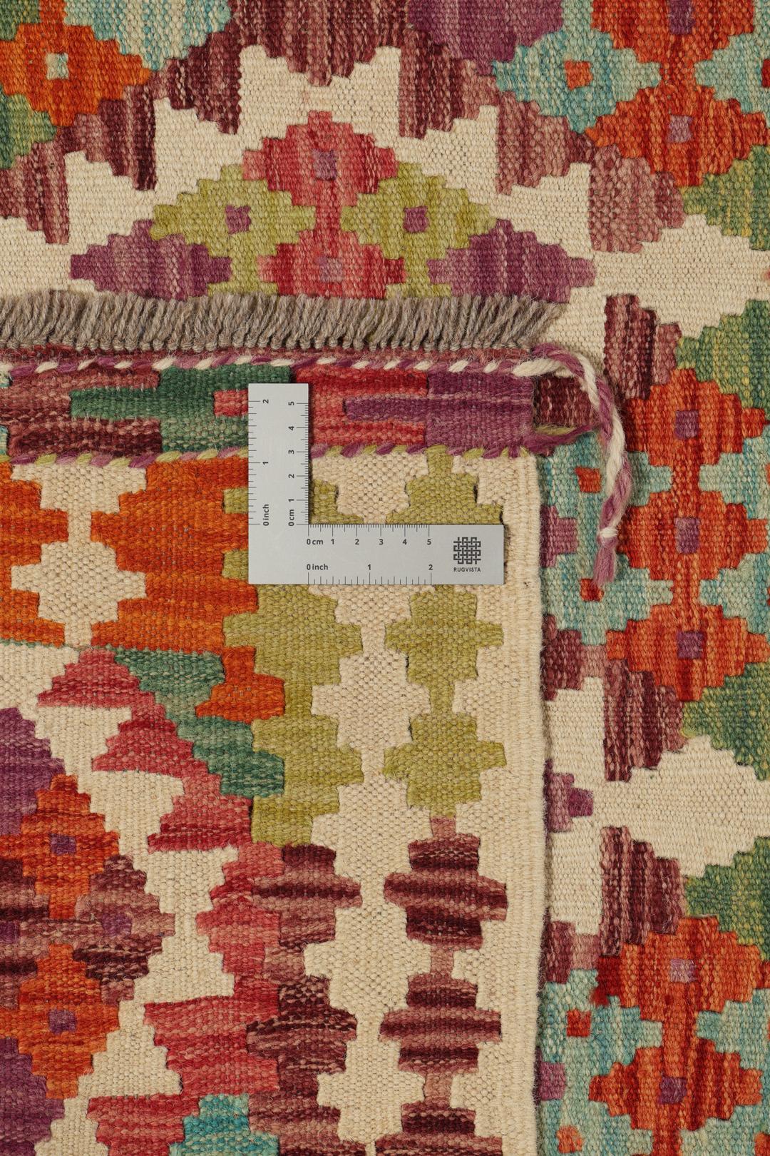Hand-woven Afghan Kelim rug featuring a vibrant, multi-coloured geometric diamond pattern.
