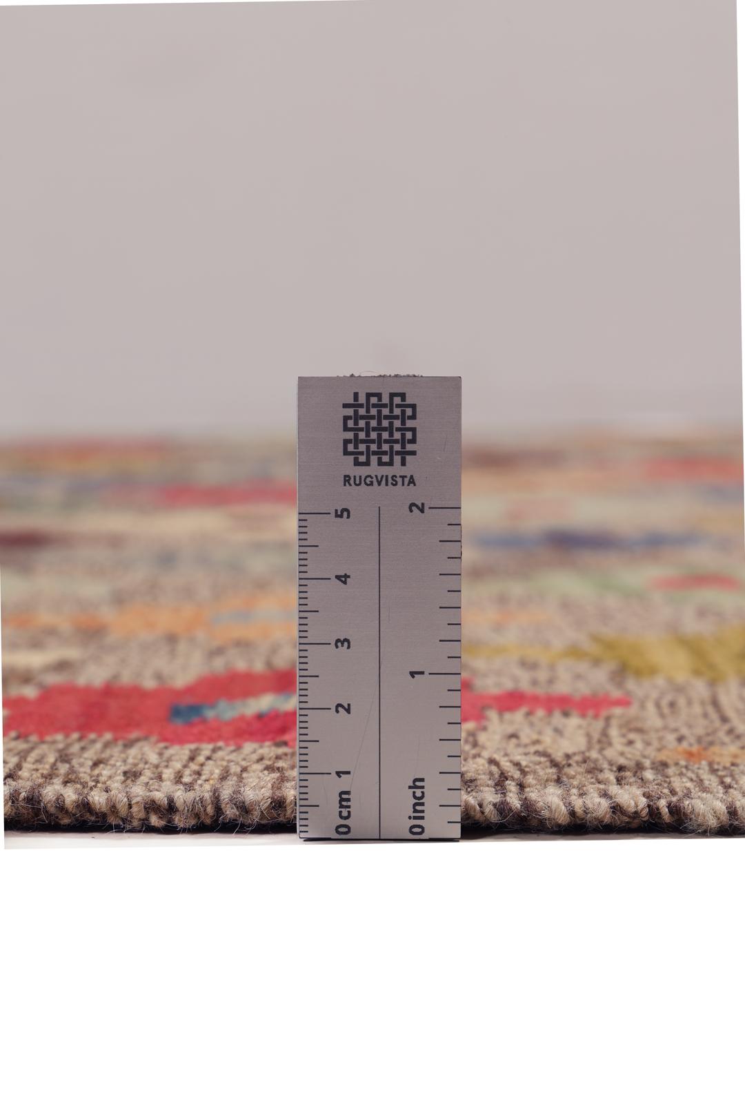 Hand-woven Afghan kelim rug with colourful geometric motifs on a grey background