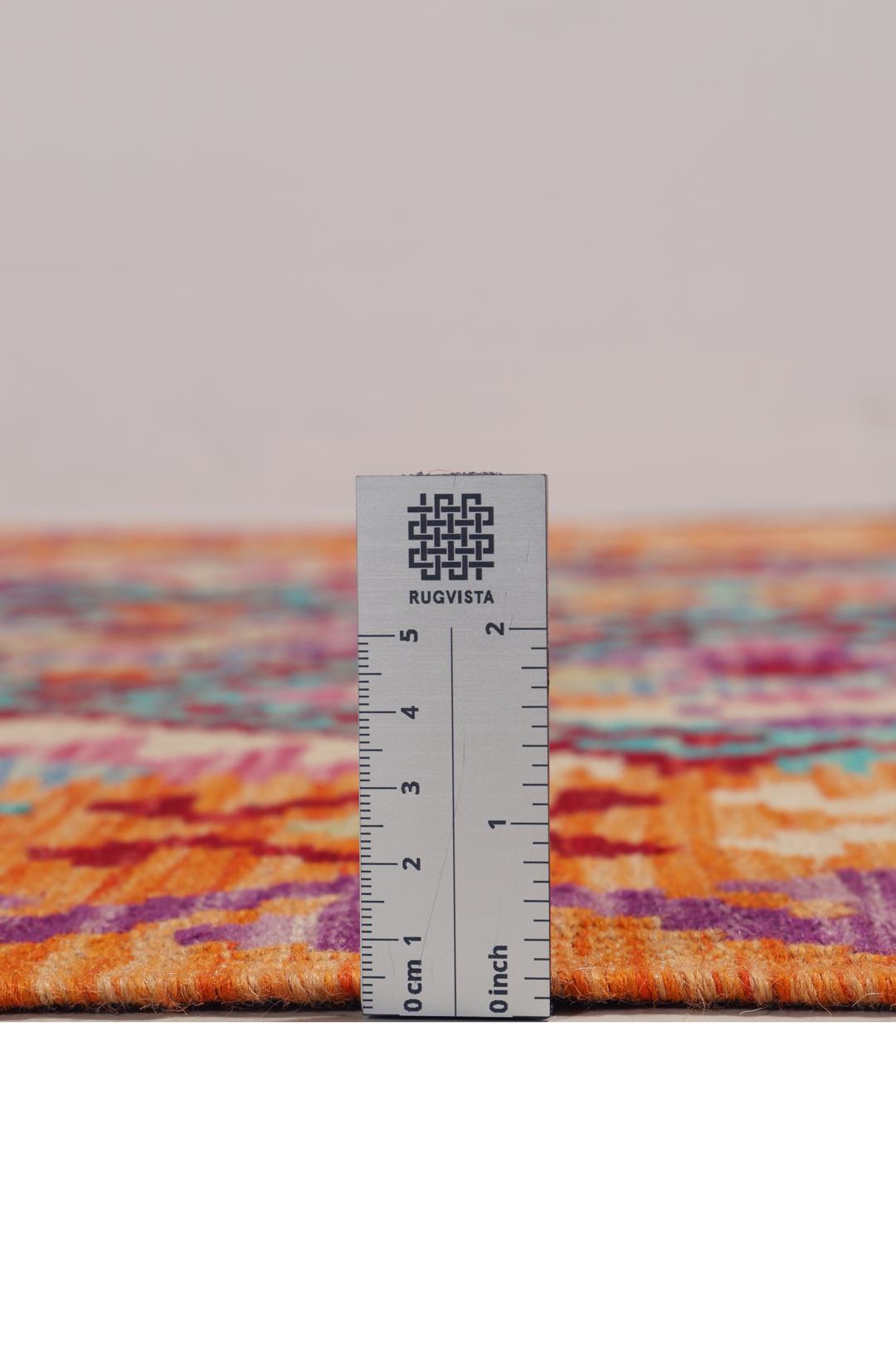 Hand-woven Afghan Kelim rug with vibrant geometric patterns in orange, teal, and purple