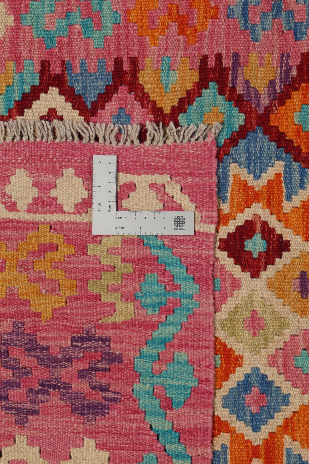 Hand-woven Afghan Kelim rug with vibrant geometric patterns in multicolor.