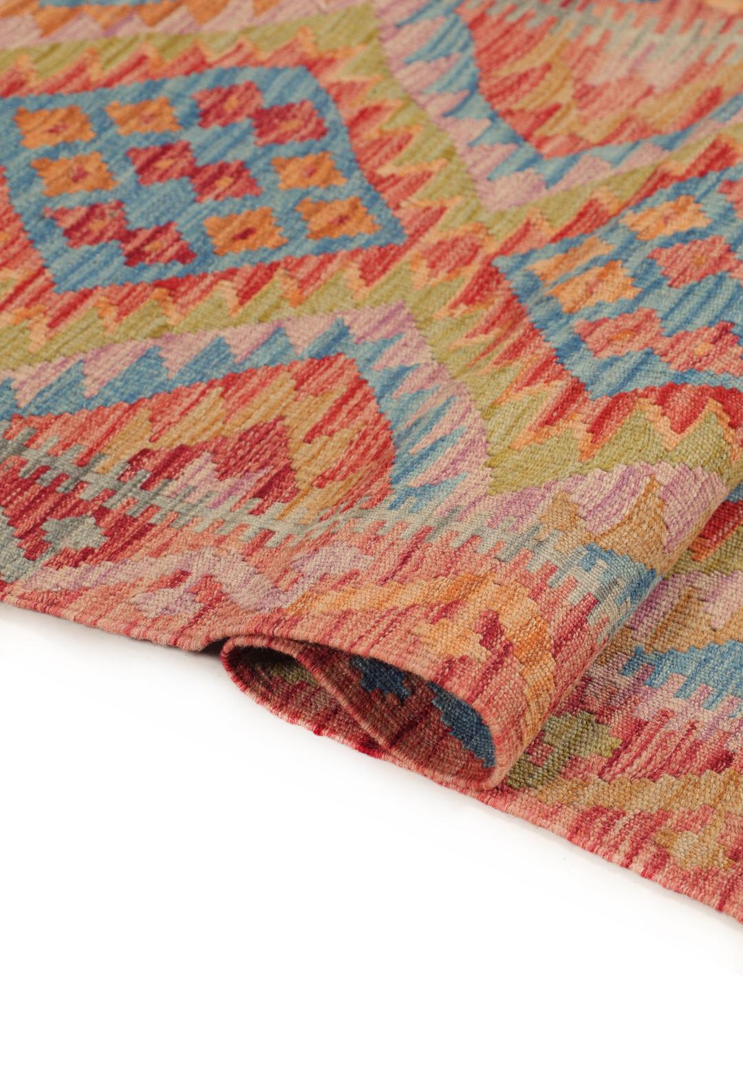 A hand-woven multicoloured Afghan runner with geometric diamond motifs.