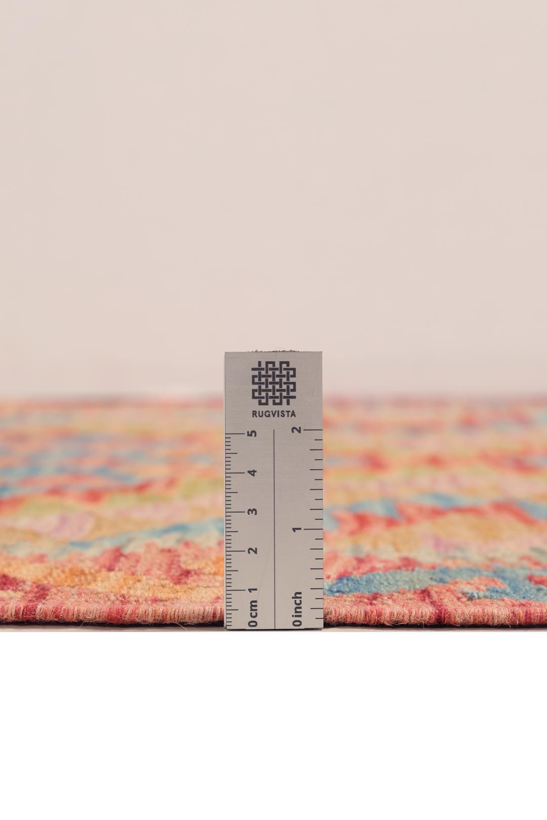 A hand-woven multicoloured Afghan runner with geometric diamond motifs.