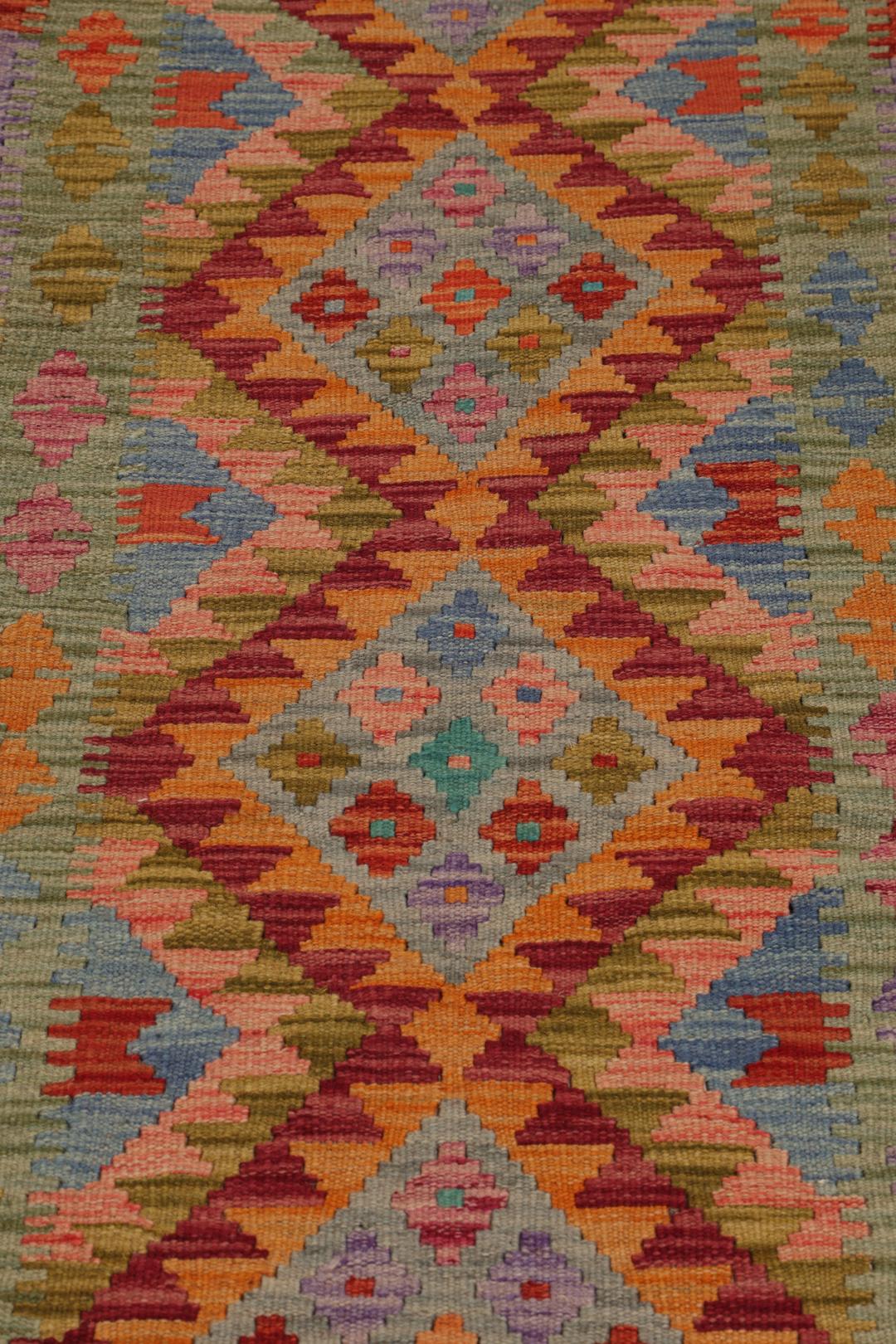 Hand-woven Afghan runner with a vibrant geometric diamond pattern in multicolor wool