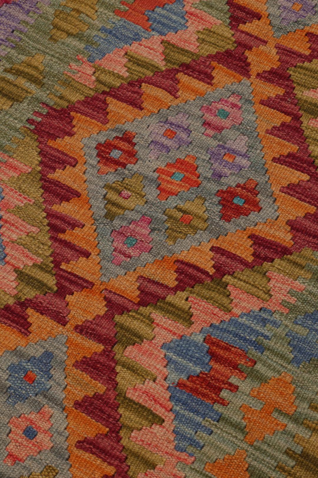 Hand-woven Afghan runner with a vibrant geometric diamond pattern in multicolor wool