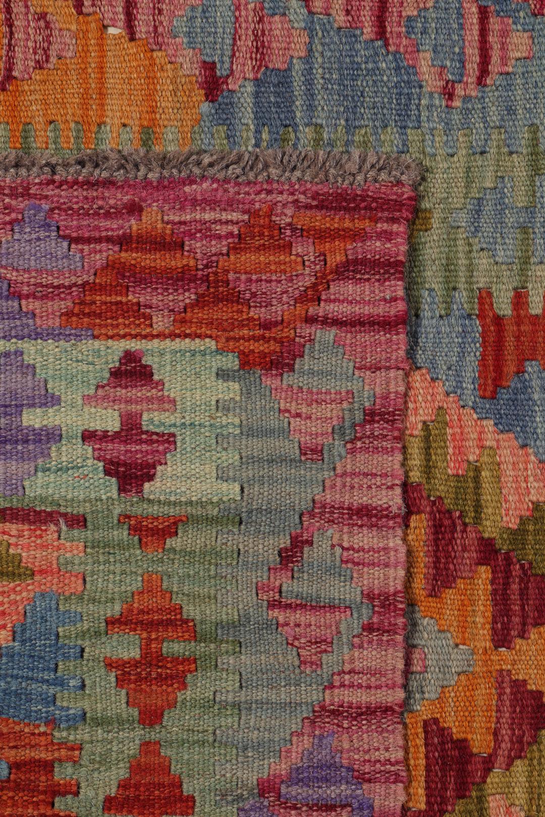 Hand-woven Afghan runner with a vibrant geometric diamond pattern in multicolor wool