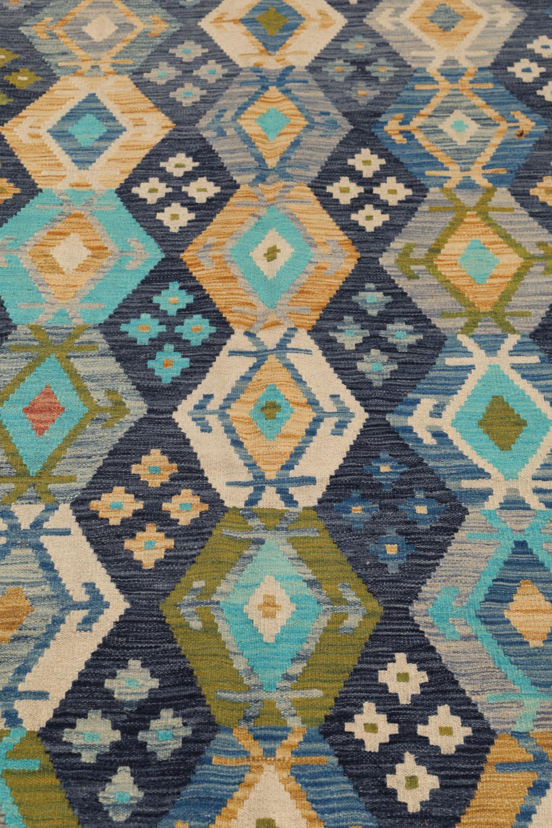 Hand-woven Afghan Kelim rug in shades of blue and teal with geometric diamond patterns