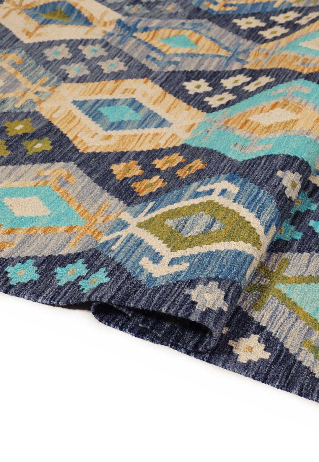 Hand-woven Afghan Kelim rug in shades of blue and teal with geometric diamond patterns
