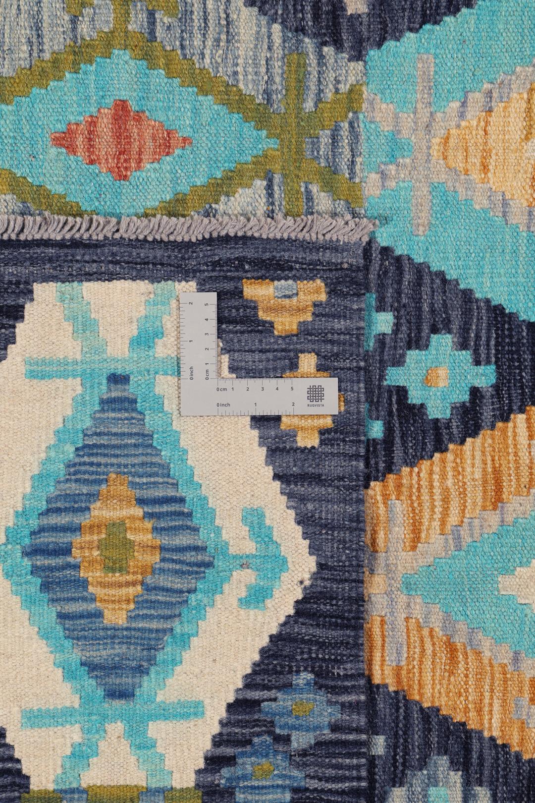 Hand-woven Afghan Kelim rug in shades of blue and teal with geometric diamond patterns