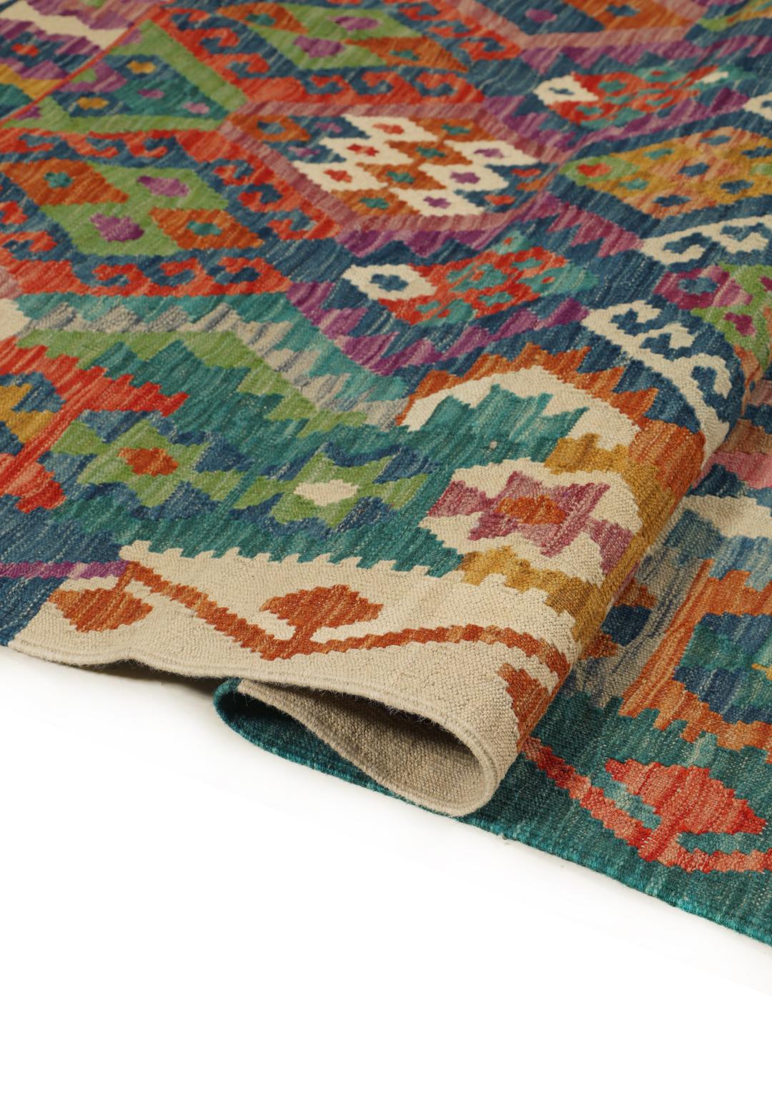Hand-woven Afghan Kelim rug with a multicolor diamond pattern on a blue background