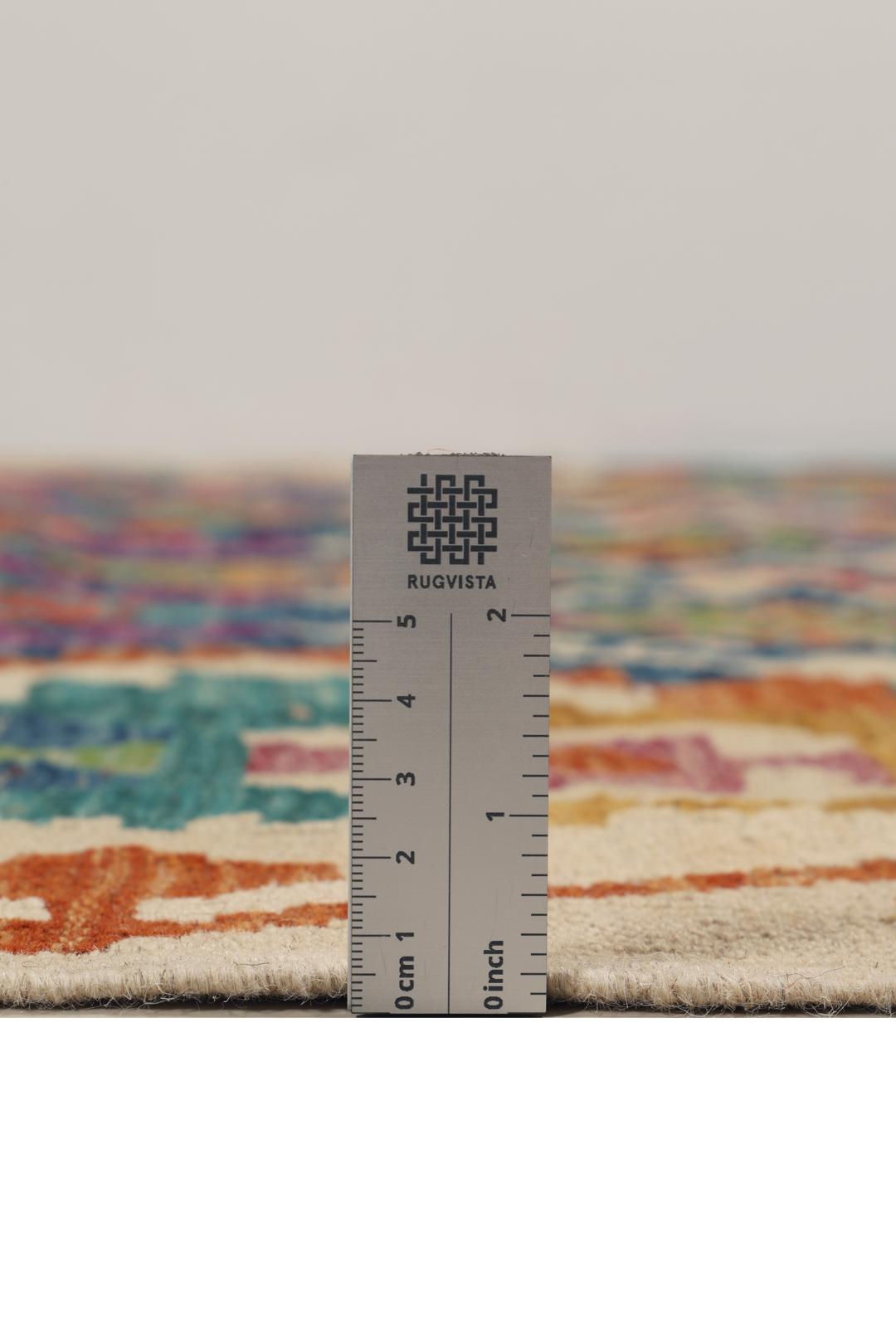 Hand-woven Afghan Kelim rug with a multicolor diamond pattern on a blue background