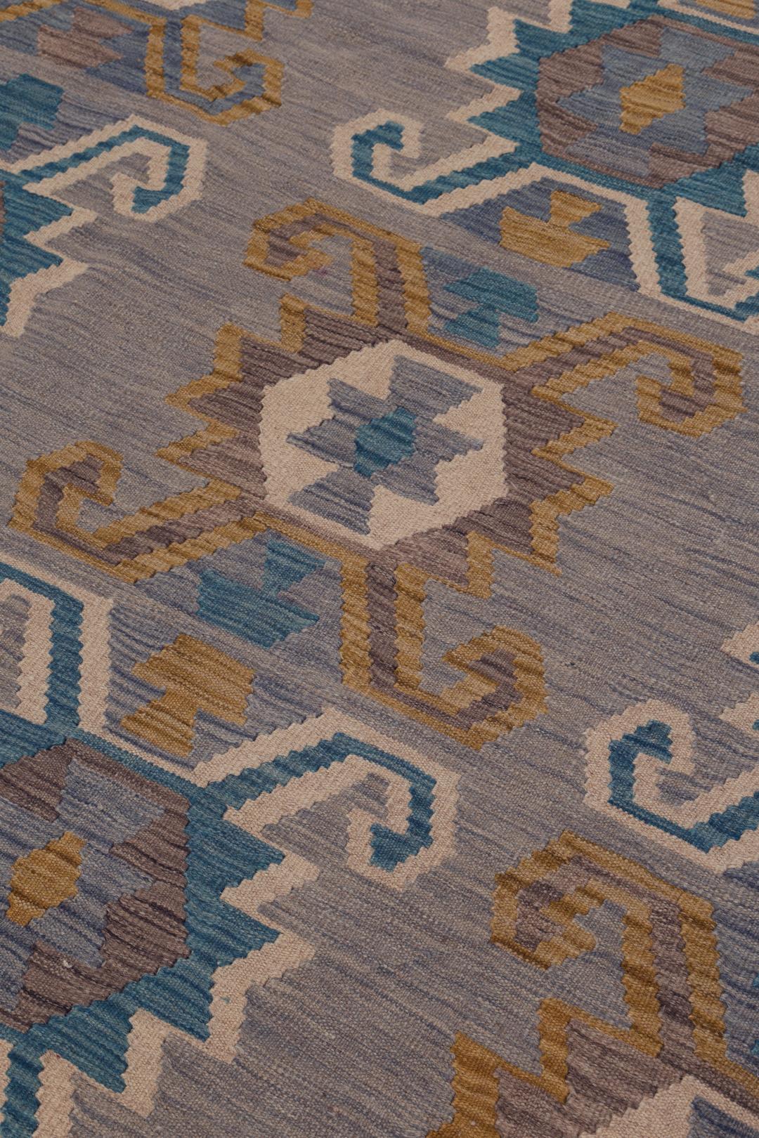 Hand-woven Afghan Kelim rug featuring geometric patterns in blue, yellow, and grey tones.
