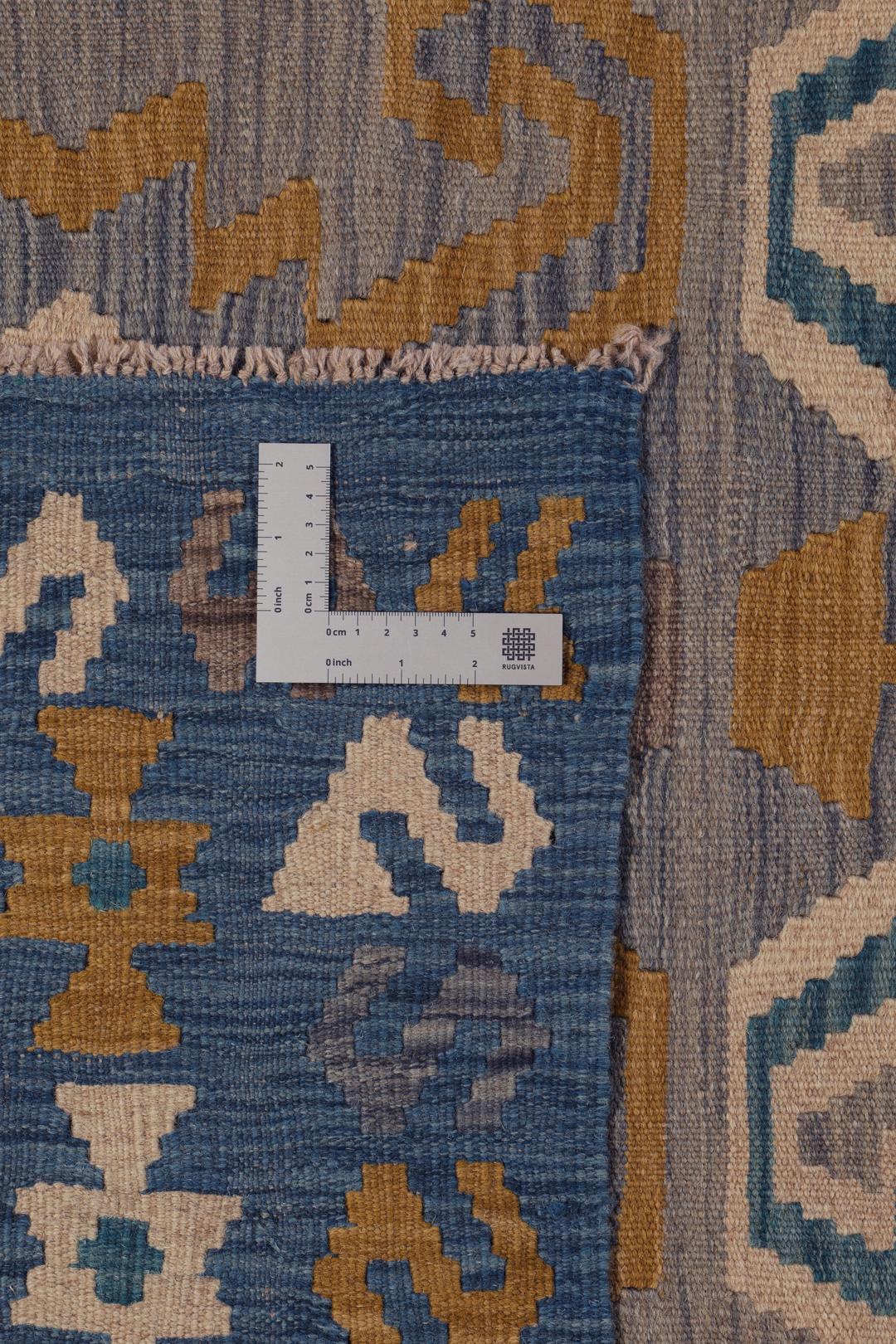 Hand-woven Afghan Kelim rug featuring geometric patterns in blue, yellow, and grey tones.