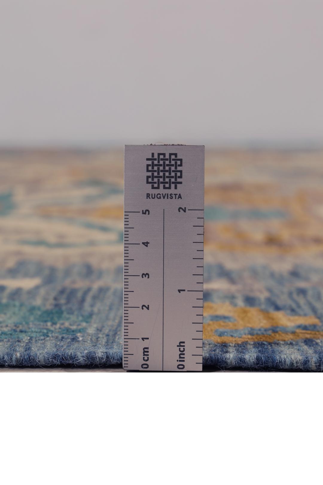 Hand-woven Afghan Kelim rug featuring geometric patterns in blue, yellow, and grey tones.