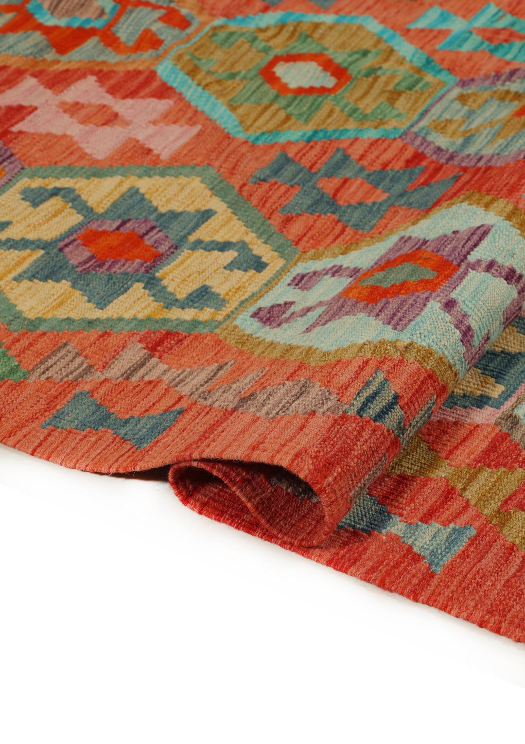 Handmade Kelim rug from Afghanistan with a colourful geometric pattern in red and multicolour tones.