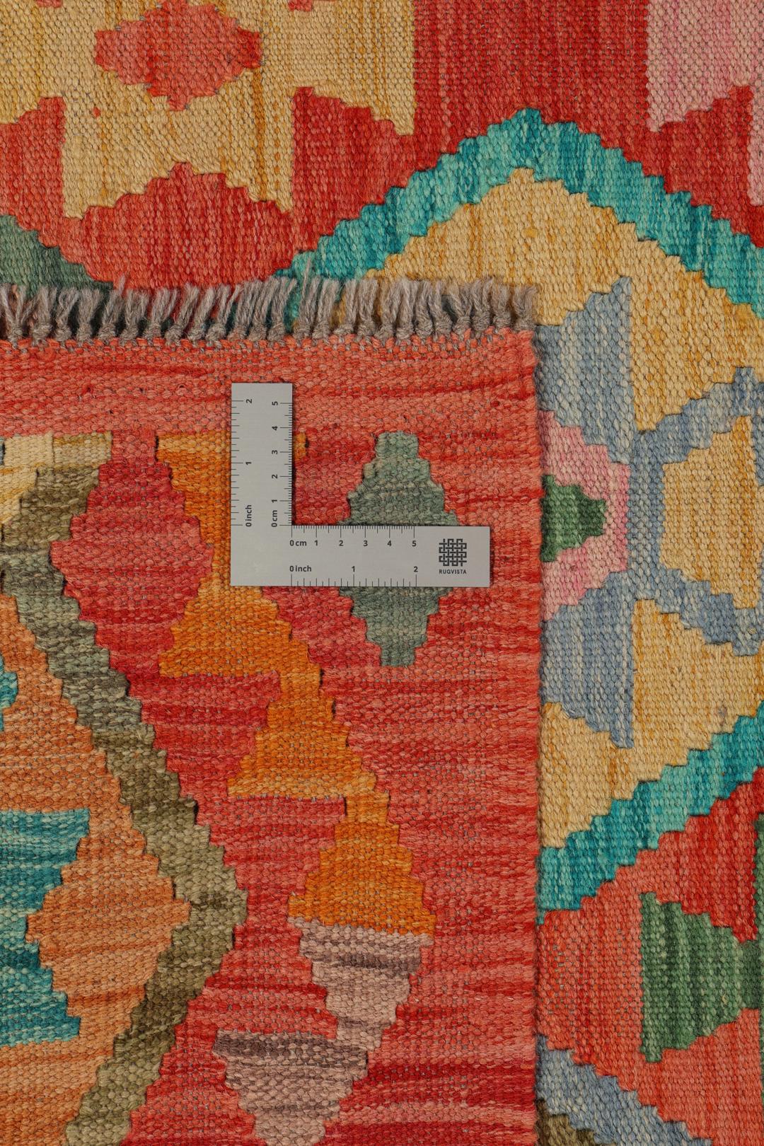 Handmade Kelim rug from Afghanistan with a colourful geometric pattern in red and multicolour tones.