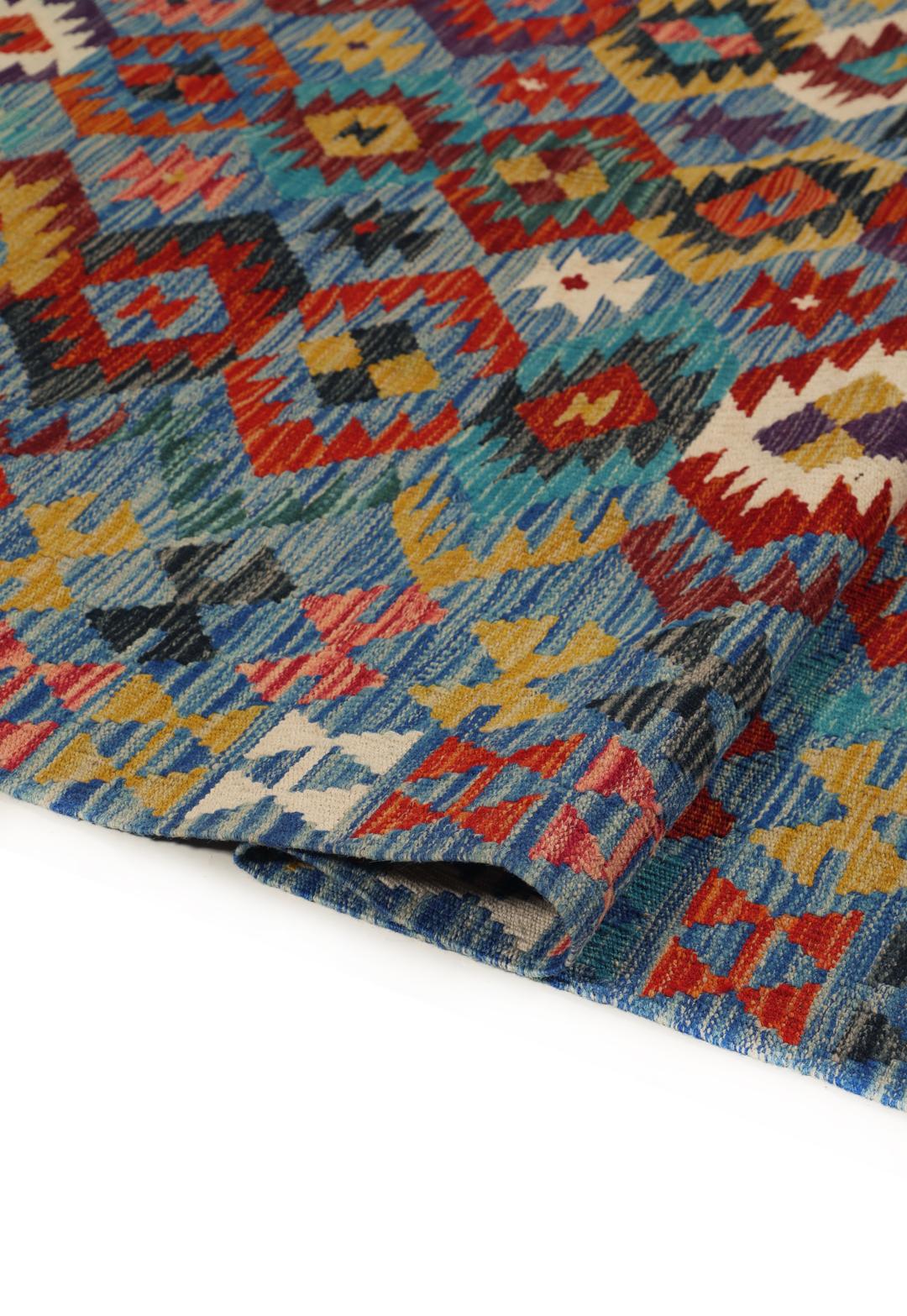 Een groot rechthoekig handgeweven Kelim-tapijt uit Afghanistan met een levendig, veelkleurig geometrisch patroon.