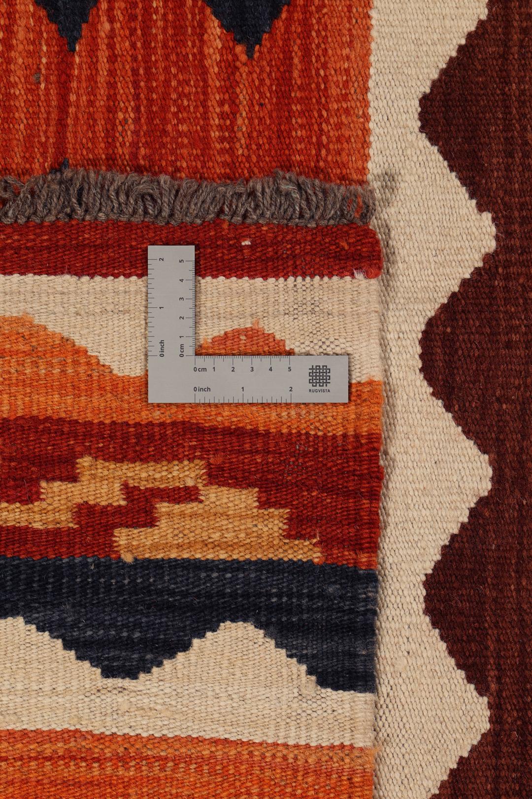 Duży ręcznie tkany afgański kilim z wielokolorowym geometrycznym wzorem i tradycyjnymi motywami plemiennymi