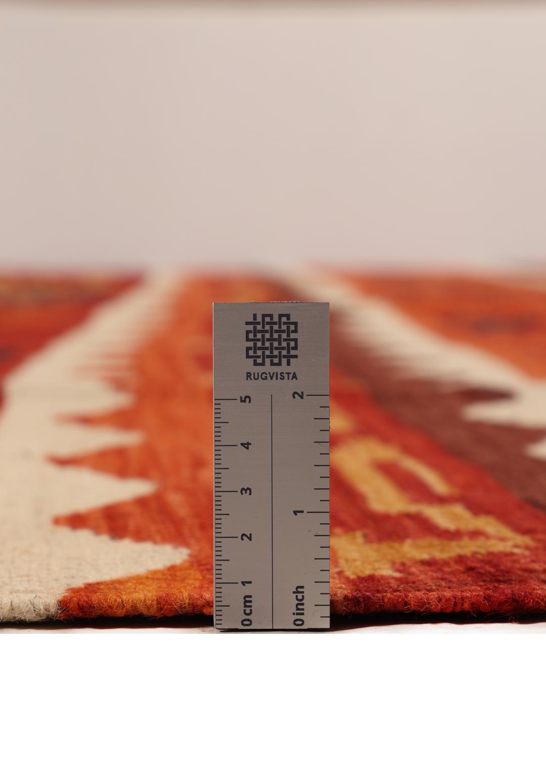 Duży ręcznie tkany afgański kilim z wielokolorowym geometrycznym wzorem i tradycyjnymi motywami plemiennymi