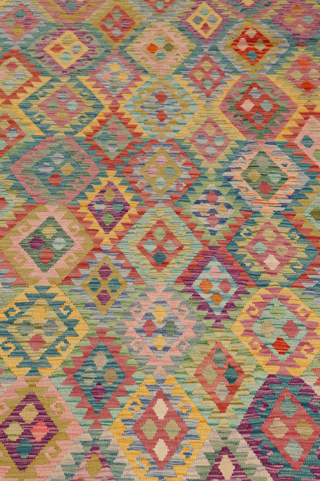 A vibrant, hand-woven Afghan Kelim rug featuring a colourful diamond pattern