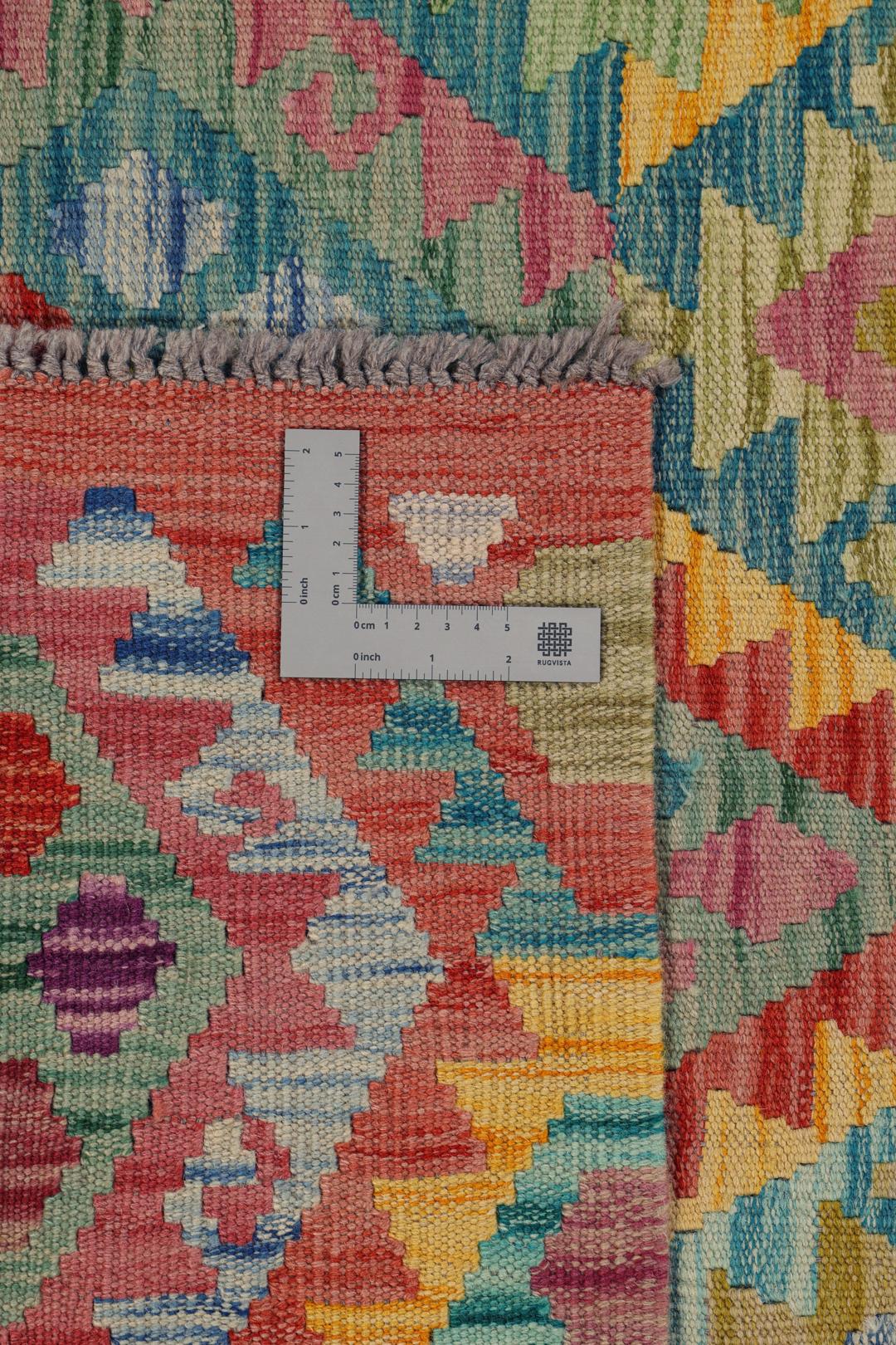 A vibrant, hand-woven Afghan Kelim rug featuring a colourful diamond pattern