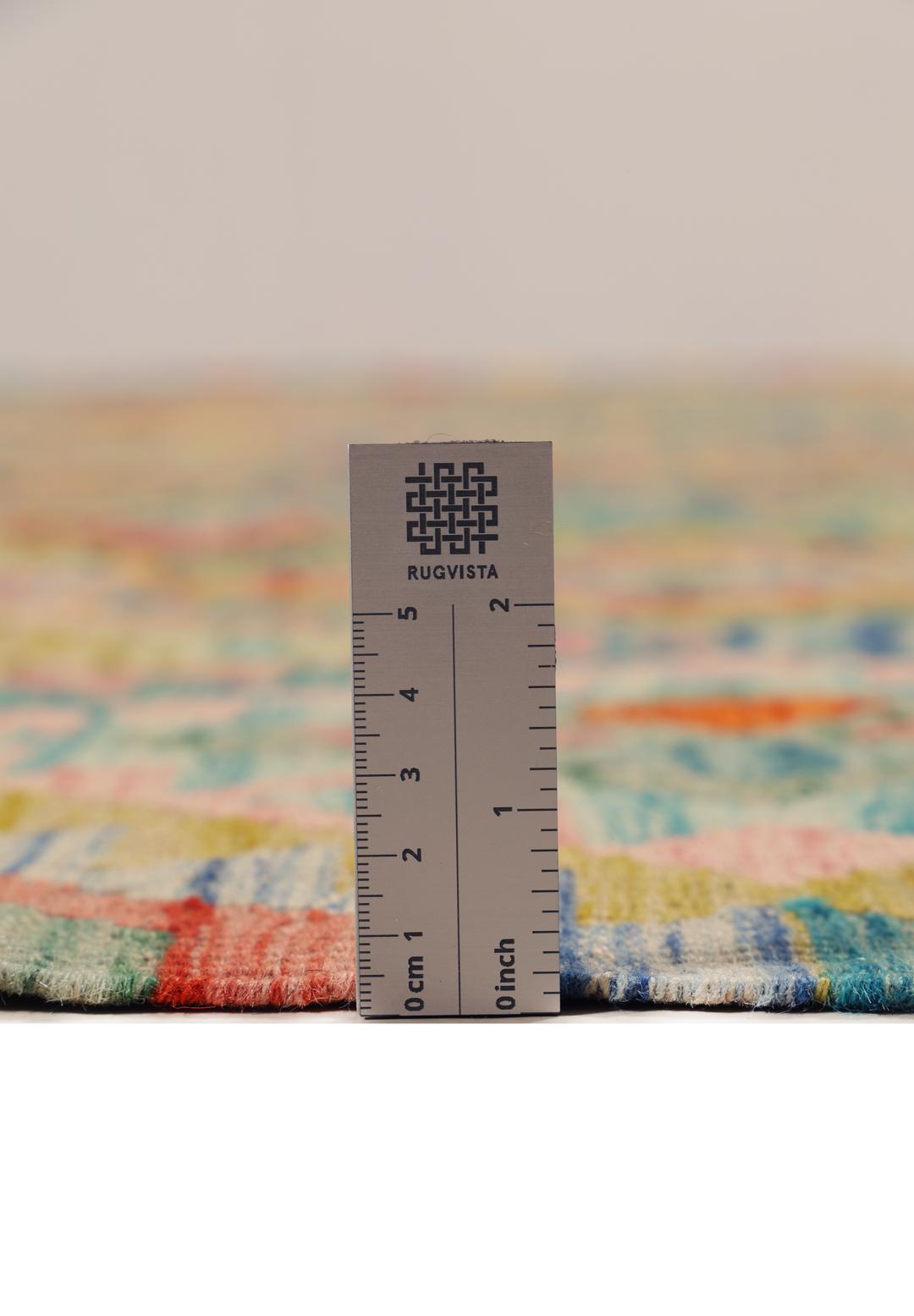 A vibrant, hand-woven Afghan Kelim rug featuring a colourful diamond pattern