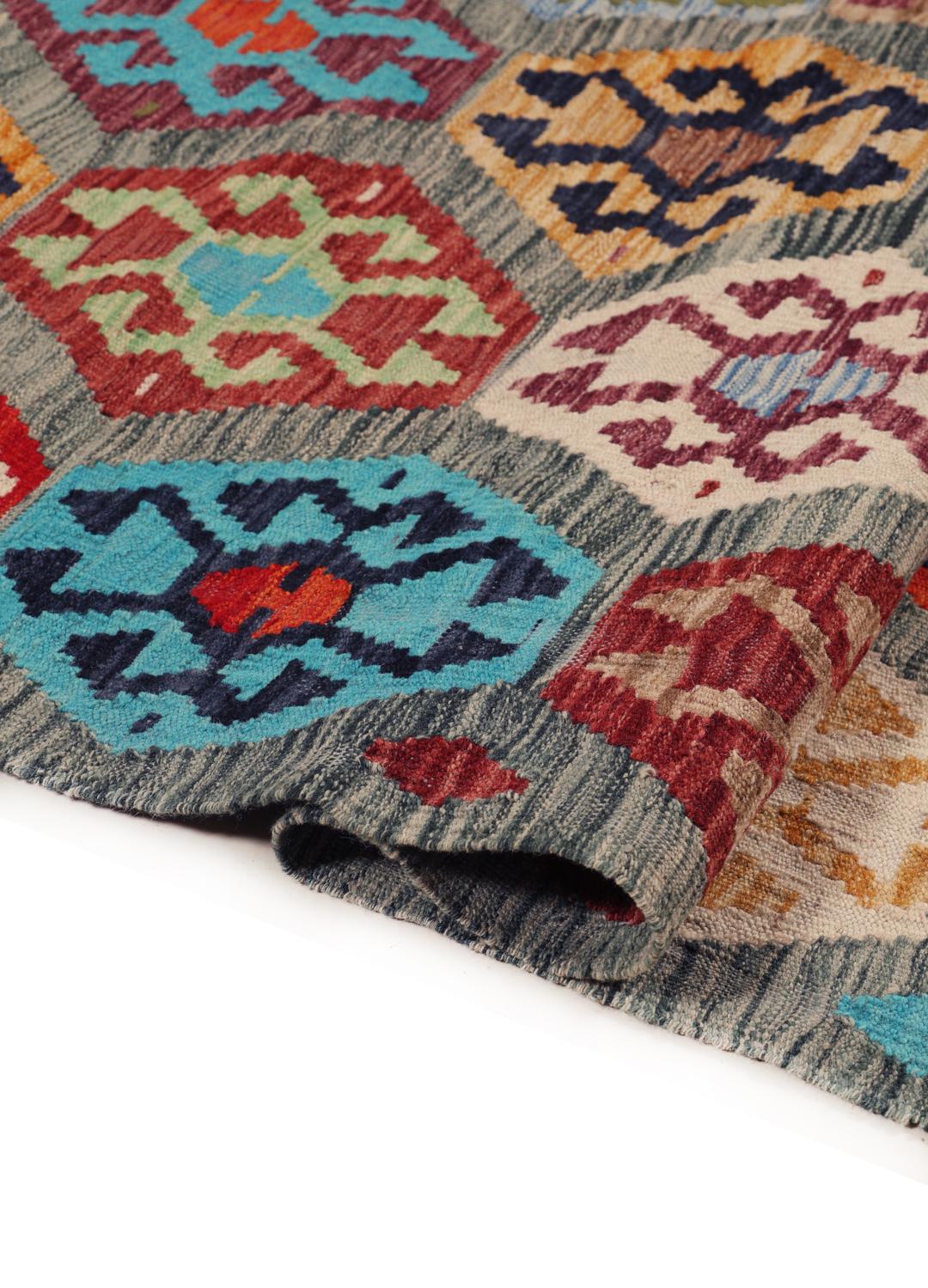 A vibrant Afghan Kelim rug with geometric patterns in multicoloured Wool.