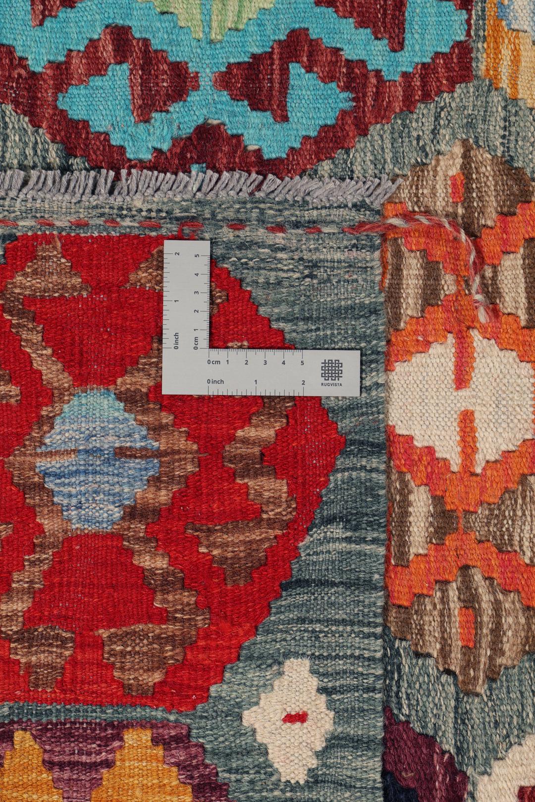 A vibrant Afghan Kelim rug with geometric patterns in multicoloured Wool.