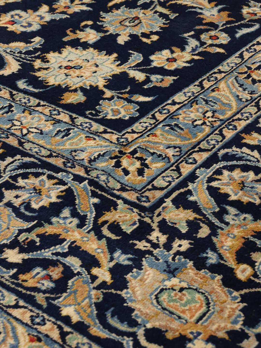 Hand-knotted Keshan rug from the Middle East in deep blue with floral patterns