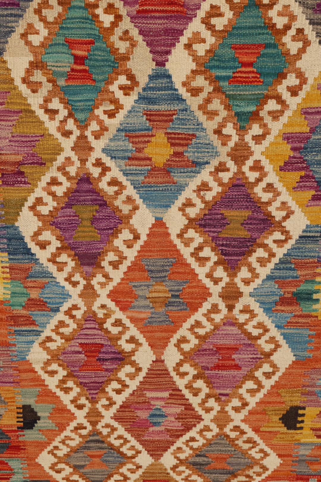 Hand-woven Afghan Kelim rug featuring a vibrant multicolor diamond geometric pattern