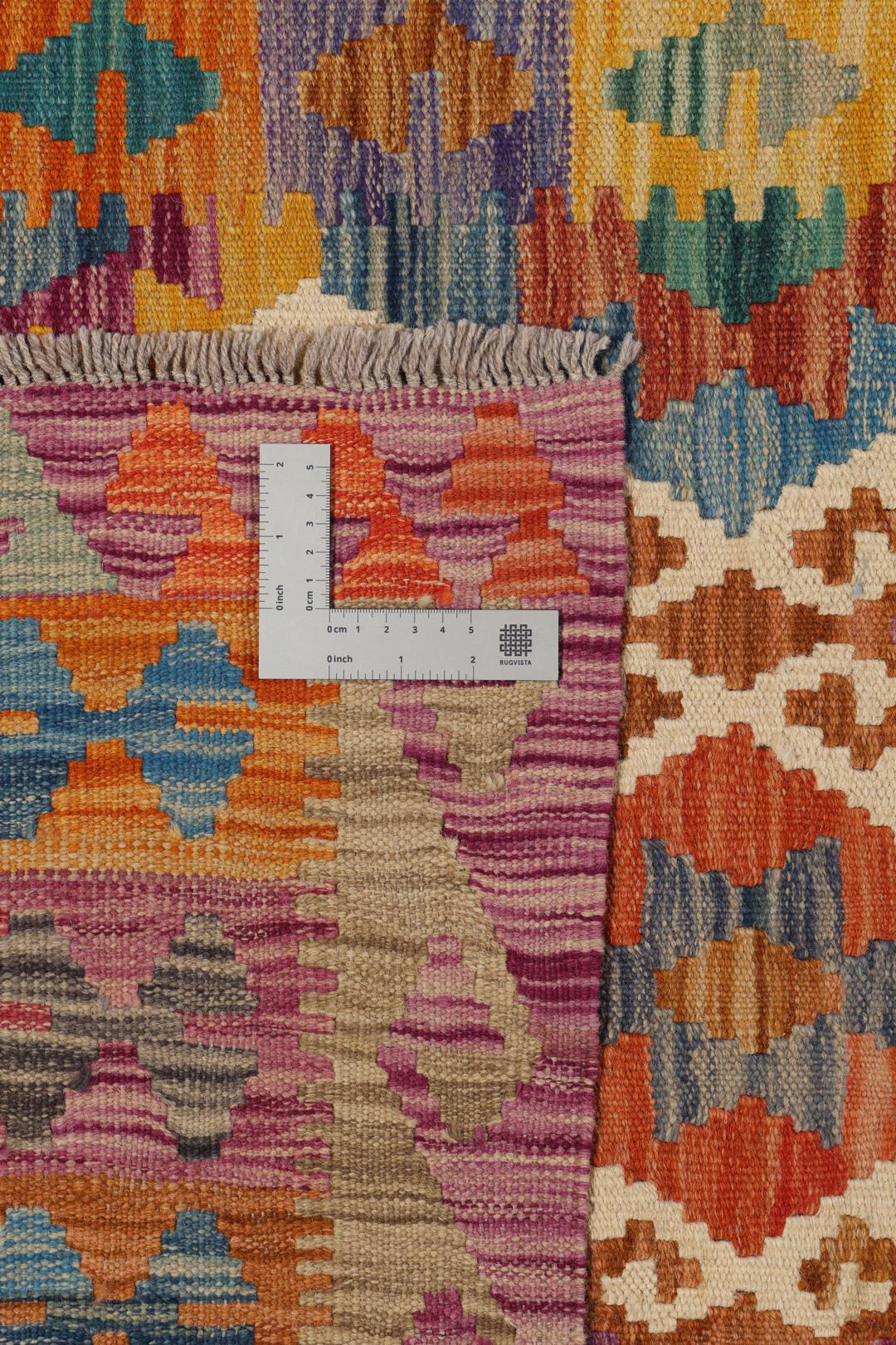 Hand-woven Afghan Kelim rug featuring a vibrant multicolor diamond geometric pattern