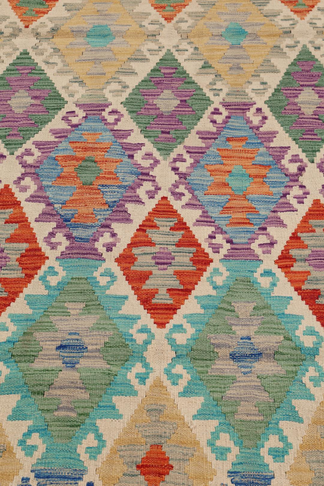 Hand-woven Afghan Kelim rug featuring a colourful geometric diamond pattern in a vibrant multicolor palette.