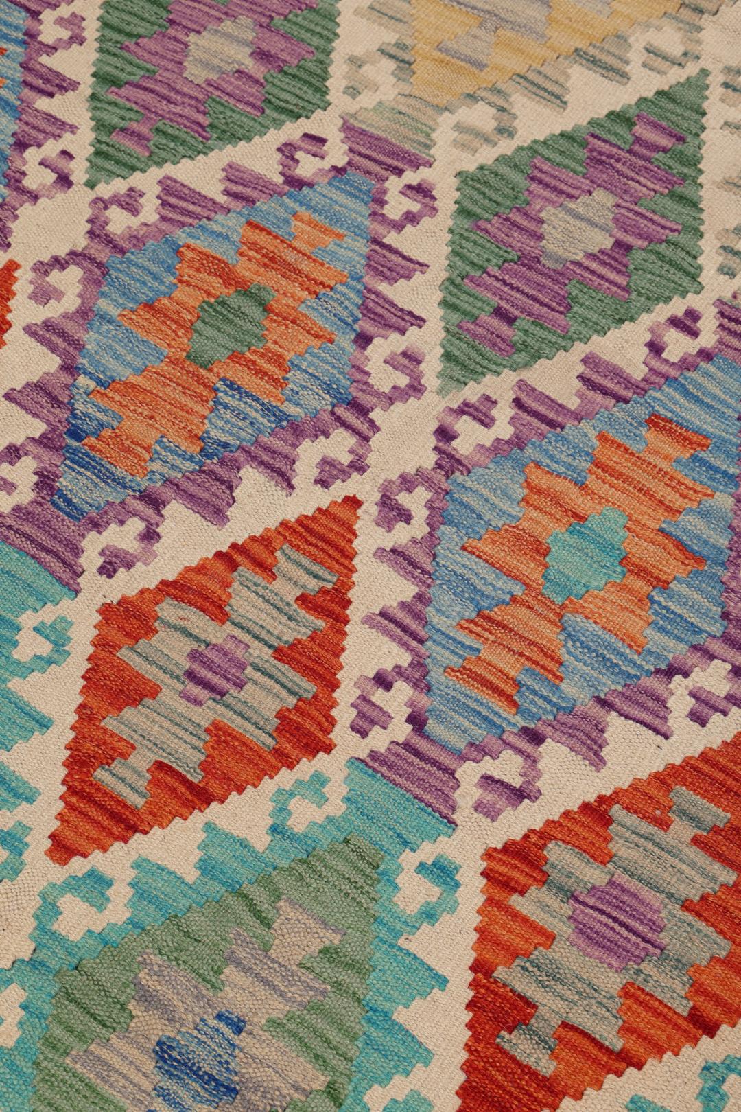 Hand-woven Afghan Kelim rug featuring a colourful geometric diamond pattern in a vibrant multicolor palette.