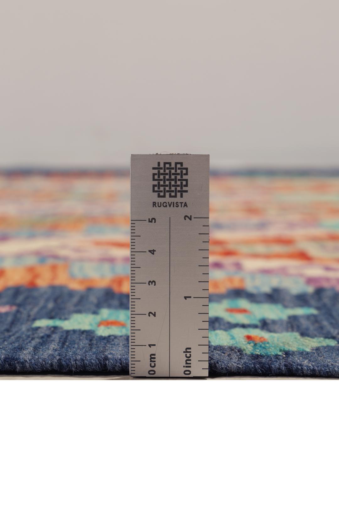 Hand-woven Afghan Kelim rug featuring a colourful geometric diamond pattern in a vibrant multicolor palette.