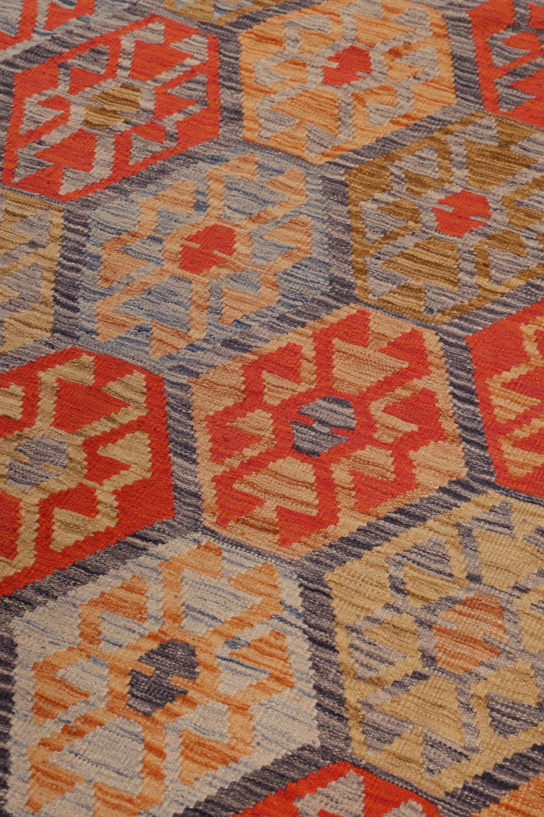 Hand-woven Afghan Kelim rug with geometric patterns in multicolour