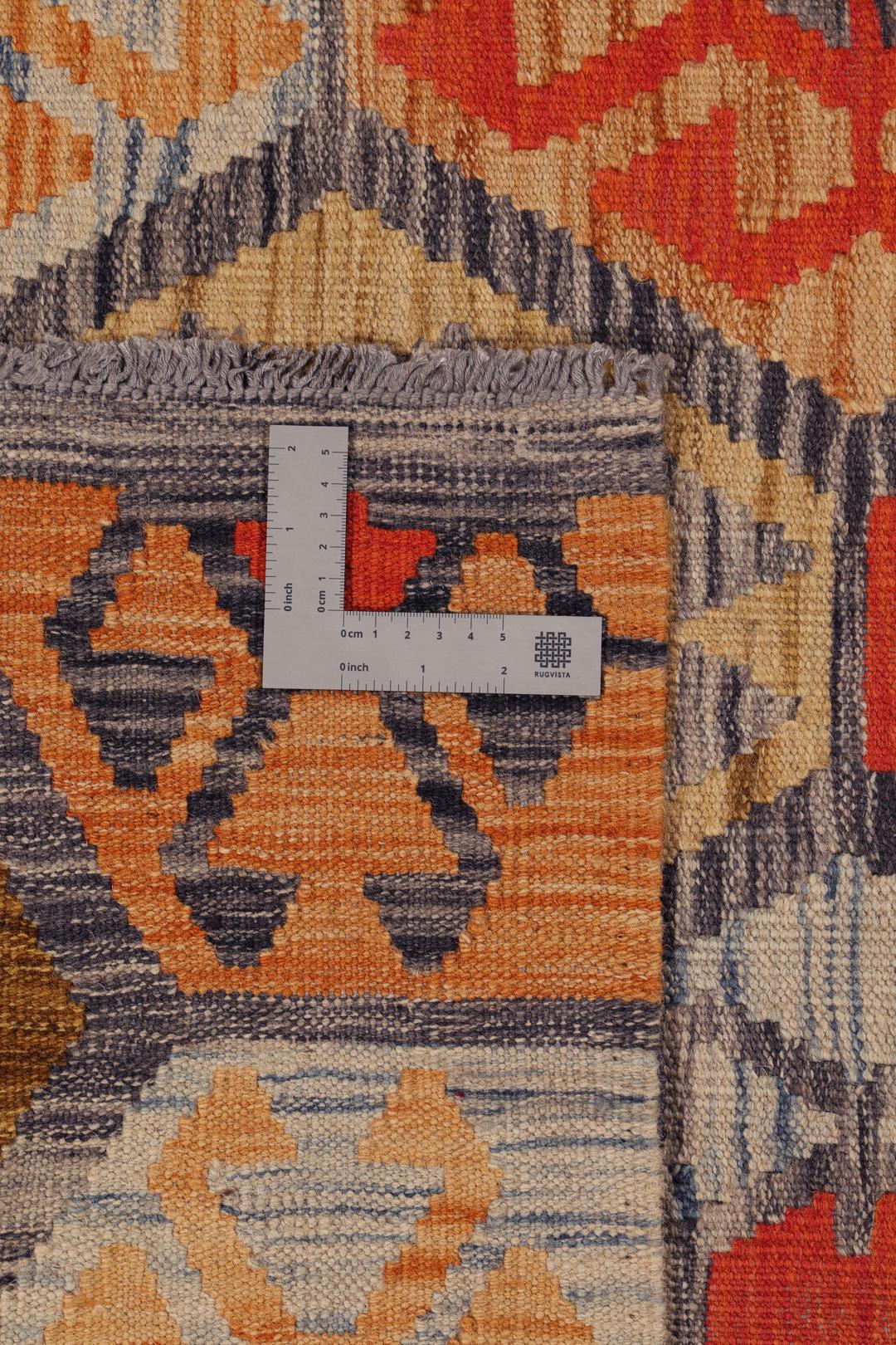 Hand-woven Afghan Kelim rug with geometric patterns in multicolour