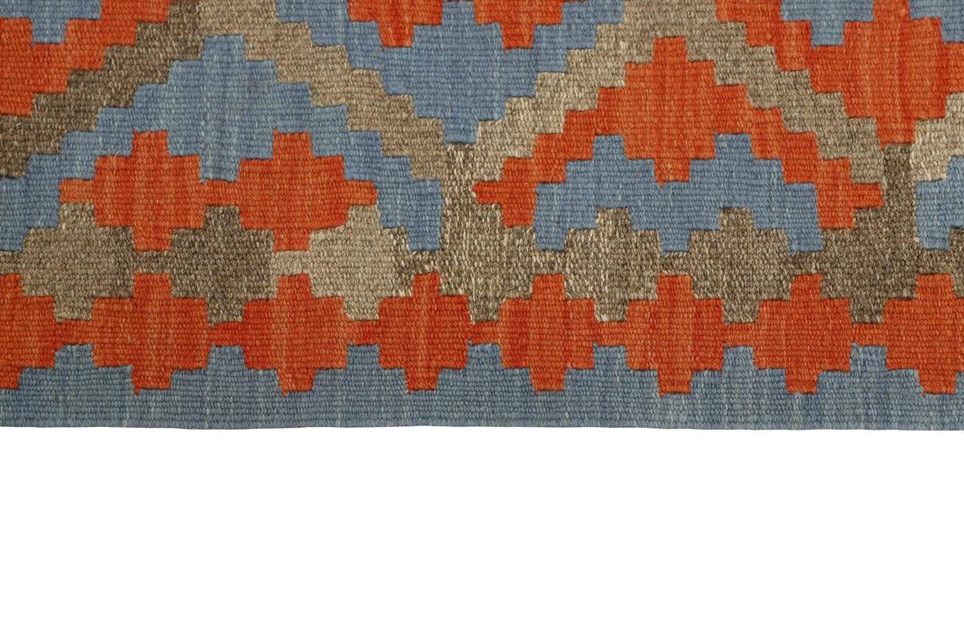 Hand-woven Kilim Qashqai rug with geometric diamond patterns in blue and red