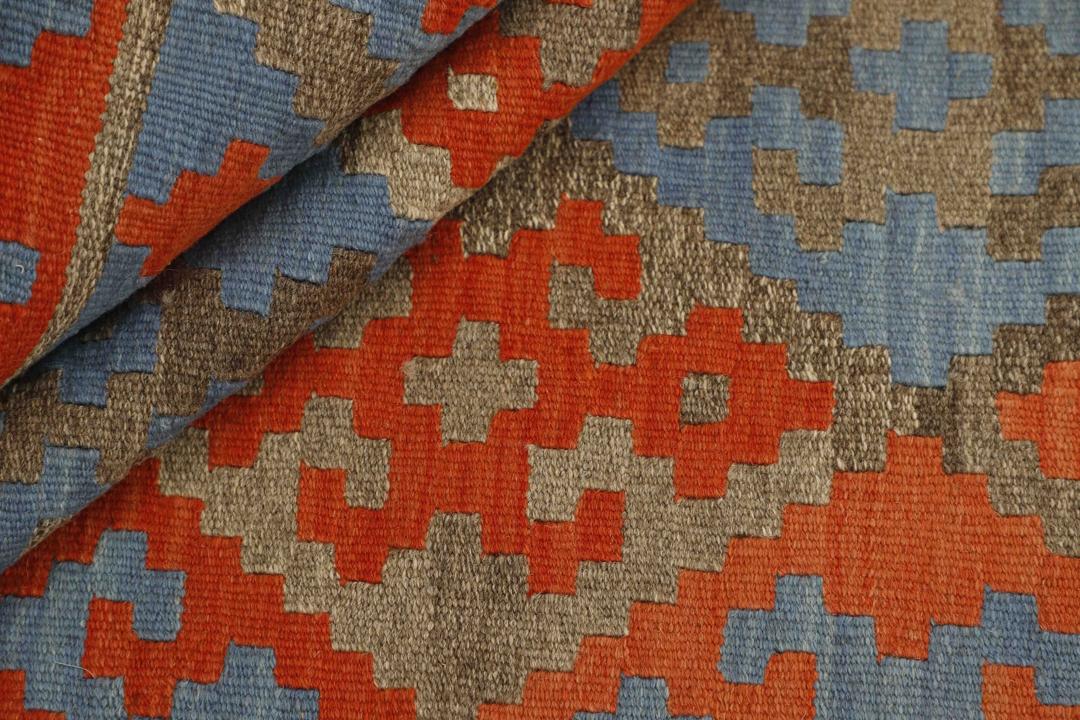 Hand-woven Kilim Qashqai rug with geometric diamond patterns in blue and red